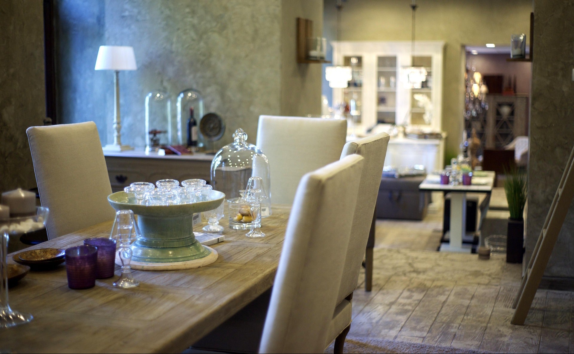 Dining room with a table set for a meal, chairs, and decorative items.
